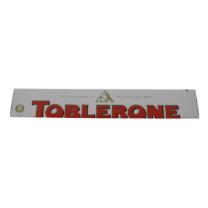 A bar of Toblerone White Chocolate with Honey & Almond Nougat, featuring the iconic triangular shape with a white chocolate coating.