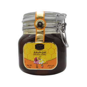 A jar of Al Shifa Honey 1kg, featuring vibrant packaging with the Al Shifa logo and honeycomb illustrations.