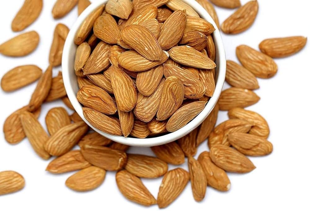 Close-up of Mamra Badam almonds, showcasing their small, wrinkled texture and rich brown color, symbolizing their uniqueness and exceptional taste in the world of almonds